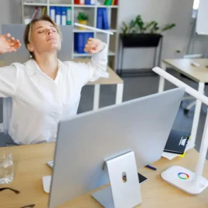 Vrouw rekt zich uit achter computer