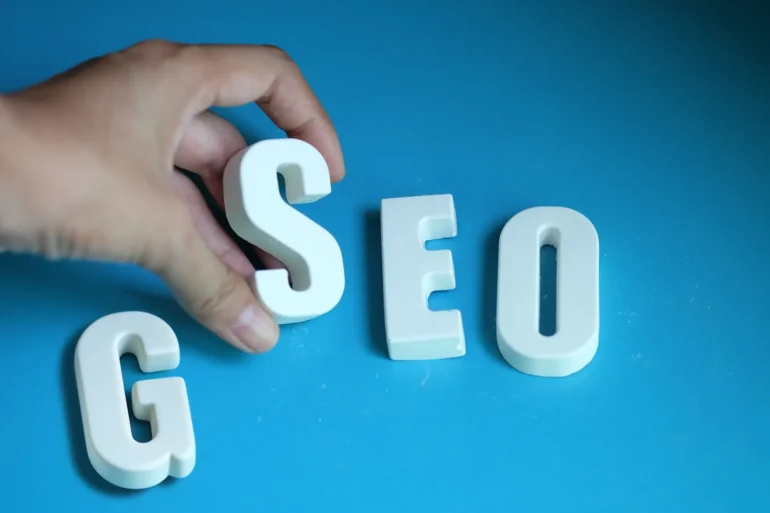 Hand takes letter s of SEO and letter G
