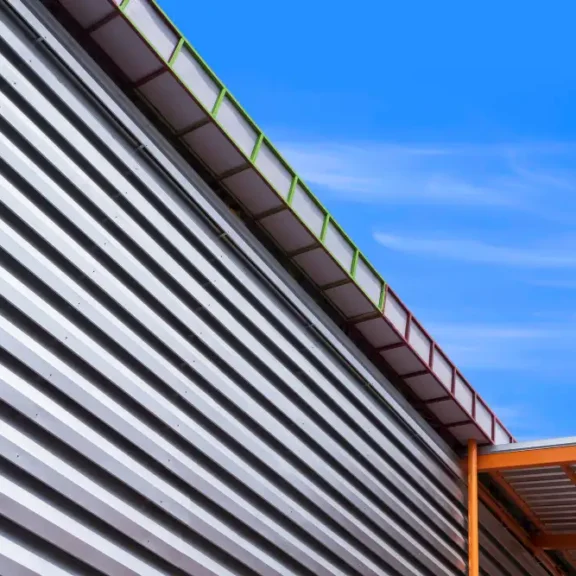 Moderne gevel van sandwichpanelen en dak met blauwe lucht